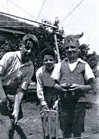 Leo Gamble, Laurie O'Toole and Neil Pickles (Curl) playing cricket in Gamble's backyard [picture].