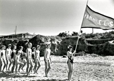 Junior life savers, Parkdale Life Saving Club,  with reel marching behind the club flag on Parkdale Beach, club rooms in the background [picture].