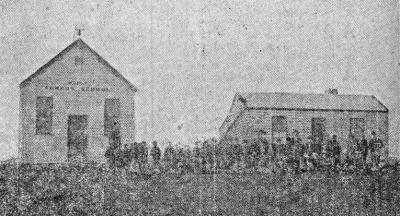 Mordialloc Common School, later Mordialloc State School with teachers' residence and the staff and pupils assembled outside.  Note the school bell [picture].