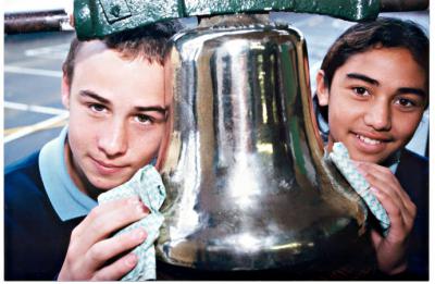Grade 6 pupils Pat O'Neill and Jean Hetaraka polishing the school's historic bell at Heatherton Primary School [picture].