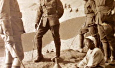 A young Egyptian boy with pot surrounded by Australian soldiers at Mena Camp Egypt [picture].