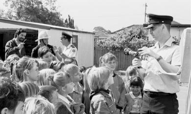 Primary school children listen to fireman talk [picture].