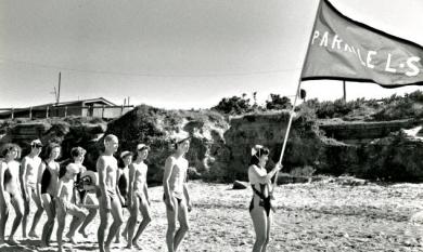 Junior life savers, Parkdale Life Saving Club,  with reel marching behind the club flag on Parkdale Beach, club rooms in the background [picture].