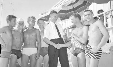 Murray Porter, Minister of Local Government congratulates Bruce Rogerson of Bonbeach winning reel and line team. 1963 [picture].