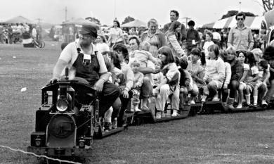 Children riding on the miniature train at the Parkdale oval on Mayor's Day 1985 [picture].