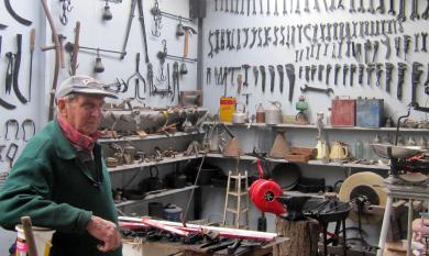 Fred Le Bon in shed with tools in background [picture].