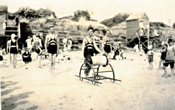 Reel and Line Team at Parkdale Life Saving Club, club house on the left, bathing box on stilts to the right and team members C Cornish, J Jones [picture].