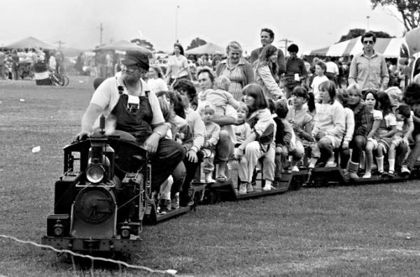 Children riding on the miniature train at the Parkdale oval on Mayor's Day 1985 [picture].