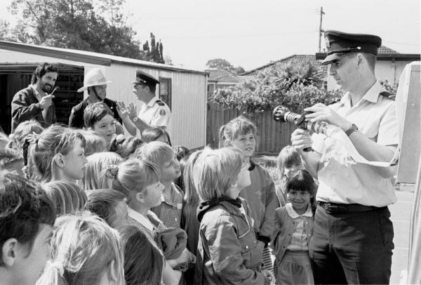 Primary school children listen to fireman talk [picture].