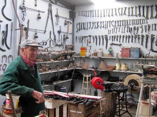 Fred Le Bon in shed with tools in background [picture].